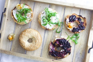 colorful bagels on rustic tray