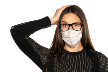 Beautiful shocked woman with protective mask on her face