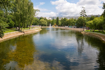 Fototapeta na wymiar MOSCOW, RUSSIA - JULY 20, 2019: Pond with a fountain in the Lianozovo Park. This park is located in the North East of Moscow.