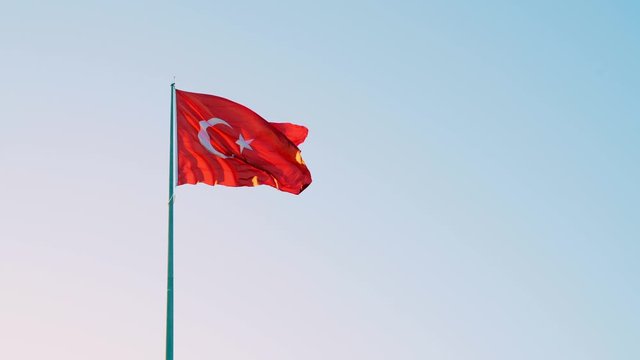 4K video of a rippling Turkish Flag on blue sky windy background.
