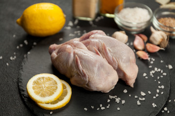 Raw quail meat on kitchen, cooking gourmet bird. Healthy diet recipe.