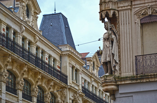 Saint-Etienne, France - January 27th 2020 : Focus on the statue of a king at the corner of a building, in front of an another edifice.