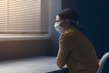 Quarantined woman with covid-19 wearing a face mask