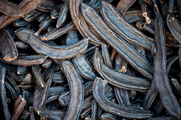 Full frame view of pile of dried carob pods on display at an outdoor market in Istanbul, Turkey