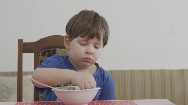 little boy playing with food, dont want to eat. Healthy food concept