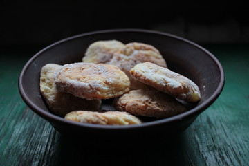 Healthy natural homemade cookies in ceramic bowl on dark rustic wooden background