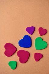 Fototapeta premium colorful hearts shapes on the orange background for valentine's day