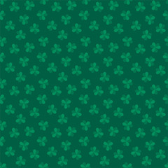 St. Patrick's Day background. Seamless pattern of clover leaves on dark green background. Illustration in flat style. Vector 8 EPS.