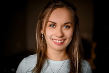 portrait of young beautiful girl with blue eyes and light brown hair