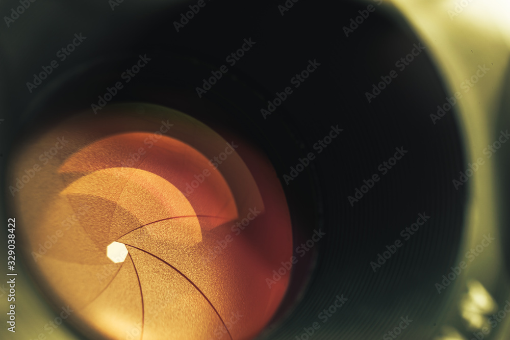 Aufkleber beautiful camera lens with orange light of glass. background pattern for design..