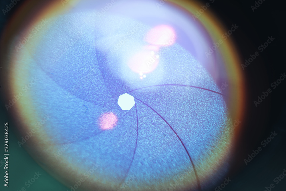 Poster beautiful camera lens with blue light of glass. background pattern for design..