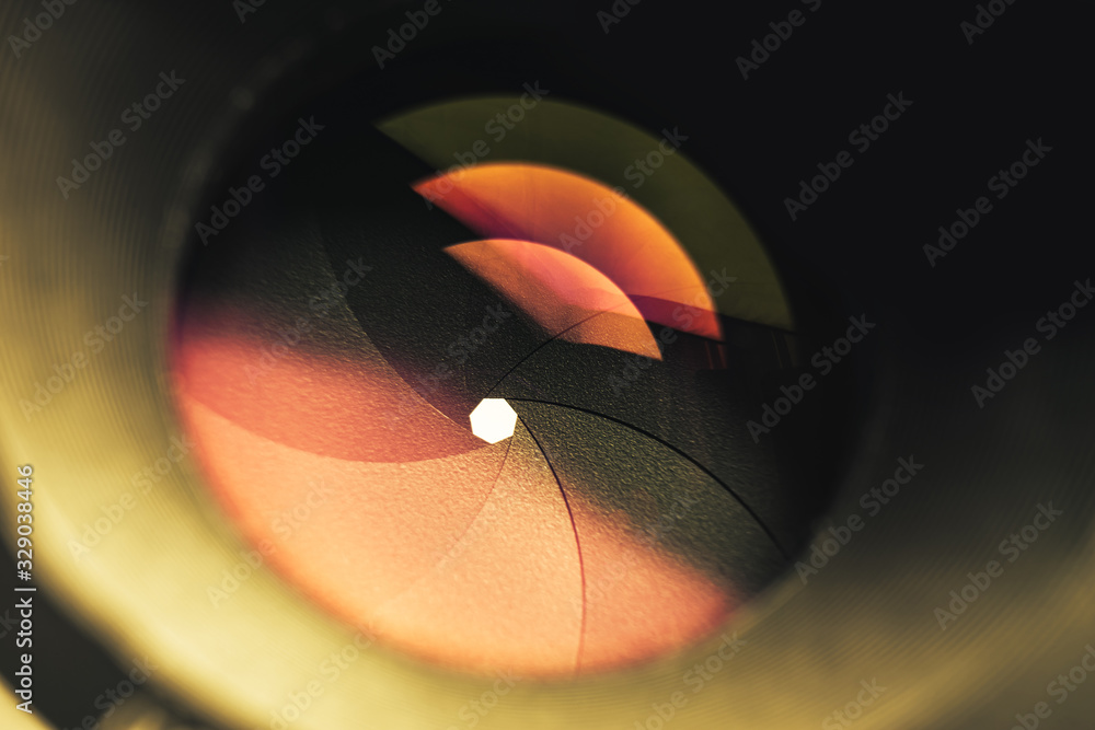 Poster beautiful camera lens with orange light of glass. background pattern for design..