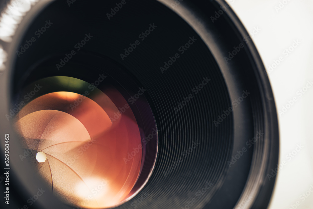 Poster Beautiful camera lens with orange  light of glass. Background pattern for design..