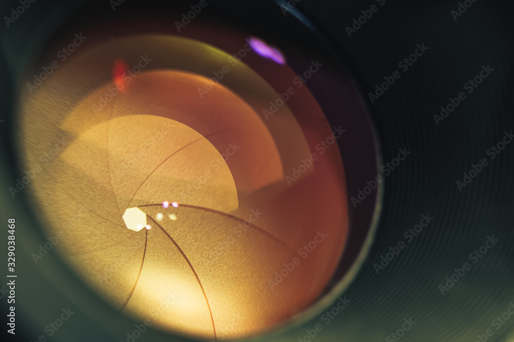 Poster beautiful camera lens with orange light of glass. background pattern for design..