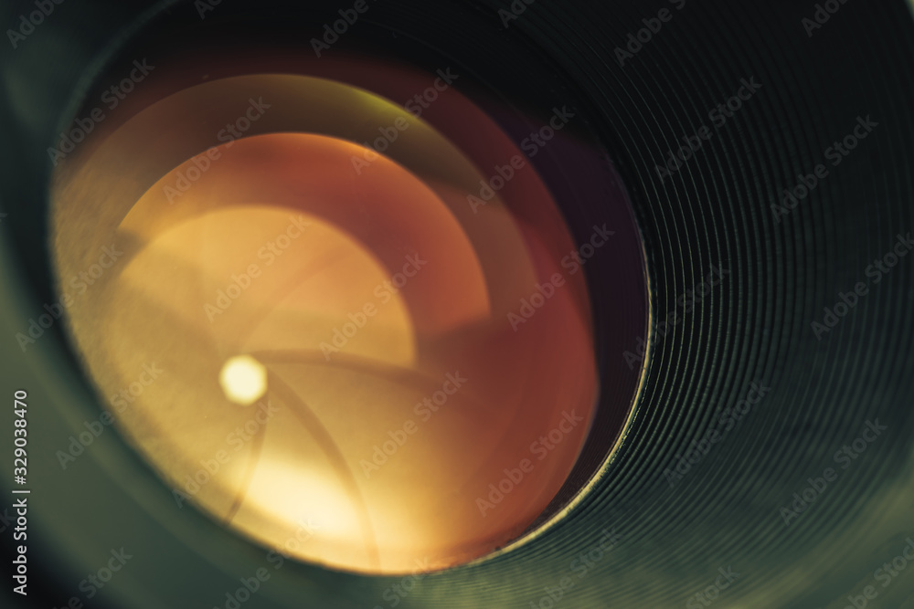 Poster beautiful camera lens with orange light of glass. background pattern for design..