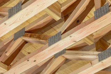 The structure of the new frame house. Open web design. Close-up of wooden structures