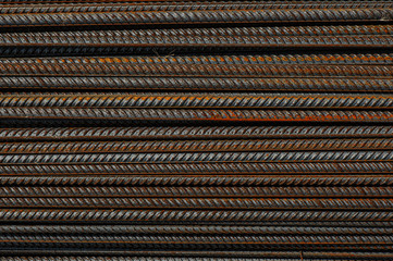 Reinforcing bars with a periodic profile in the packs are stored in the metal products warehouse. Background for photo collages
