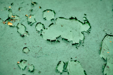 Close-up of a weathered green moody background with the paint flaking off