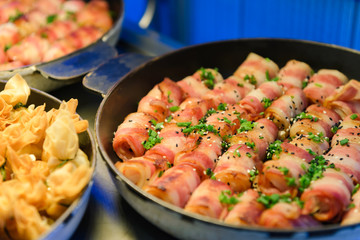 Prawn wrapped with bacon and rosemary. baked appetizer. Close-up shot.