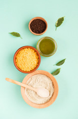 Cosmetic bath salt, grape gomaj for the face, coffee scrub for the body on a mint background. Spa cosmetic, zero waste.