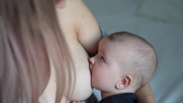 Young Beautiful Blonde Mother Breastfeeding Her Stock Photo 1064021588