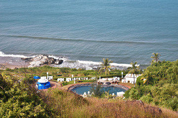 a beautiful area with swimming pool from the top of a hill near a beach