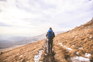 Fototapeta premium Man Hiker Walking Mountains Winter Landscape Adventure Lifestyle
