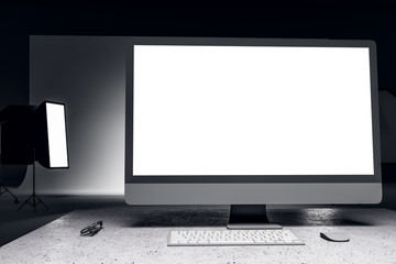 White computer screen in contemporary photo studio