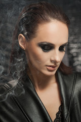 Fototapeta na wymiar Closeup portrait of a serious lady with smoky eye makeup