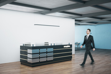 Businessman walking in office reception table