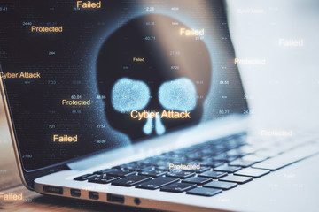 Laptop with cyber skull and hacker attack interface.