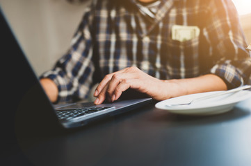 Business people wear casual clothes and work with laptops in the office.