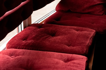 Red velvet pillows on a bench closeup
