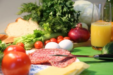 We prepare fresh and useful breakfast from bread, tomato, sausage, cheese, greens
