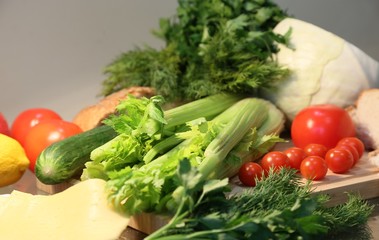 Still life from fresh vegetables: celery, tomatoes, greens, cabbages