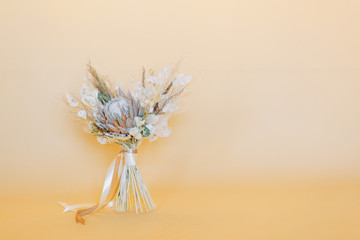 Stylish bouquet for a wedding in the style of finart. Fall bride's bouquet. Floristics of dried flowers.