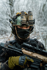 Airsoft man in black camouflage uniform with machinegun with optical sight. Soldier in the winter...
