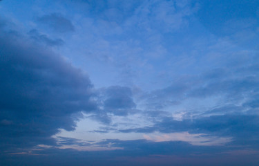 Obraz premium Dark cloudy sky with red reflections at sunset.