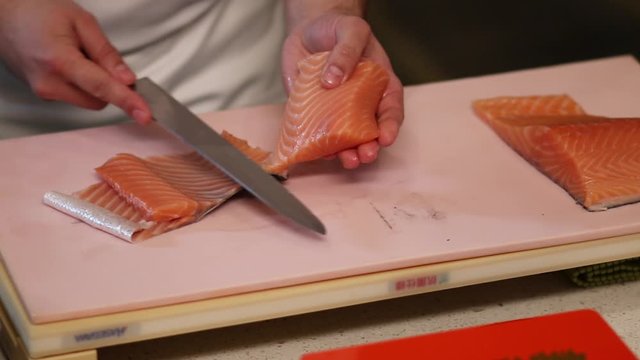 Cutting georgeous red fish fillet into neat slices