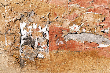 An old, stripped wall with layers of peeling old paint