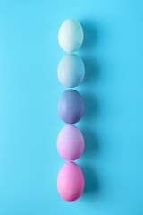 Five easter eggs on blue surface. Colorful easter eggs decoration. Flat lay, top view. with copy space for text.