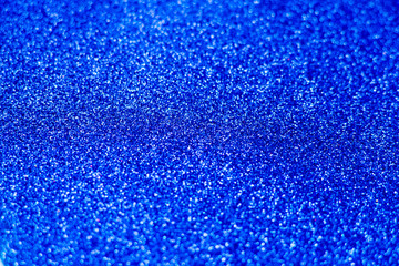 Blue classic sparkle background. Bright navy blue texture. Selective focus.