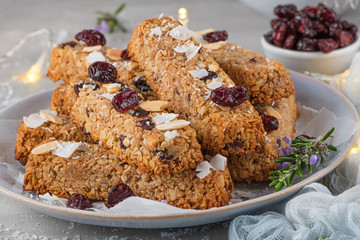 Granola bar. Healthy snack. Cereal granola bar with nuts, fruit, coconut and cranberries on a christmas table