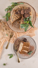 Slice of delicious naked chocolate and hazelnuts cake on table rustic wood kitchen countertop. Top view. Flat lay