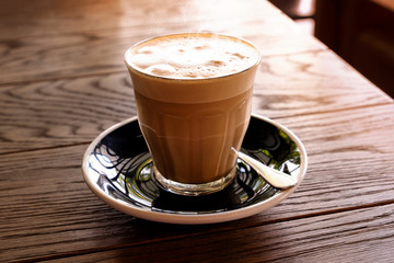 Hot latte coffee on a wooden table