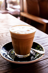 Hot latte coffee on a wooden table