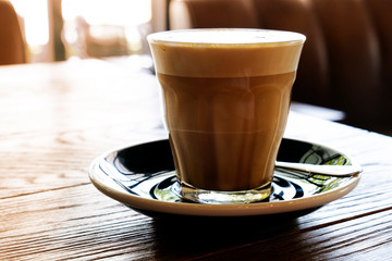 Hot latte coffee on a wooden table