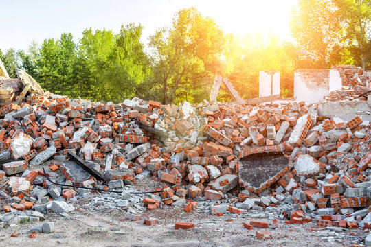 Close-up view ruins of old demolished industrial building. Pile of concrete and brick rubbish, debris, rubble and waste of destruction ruins of abandoned actory or plant. Earthquake city landscape
