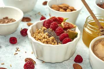 healthy breakfast, oatmeal with raspberries and honey, top view