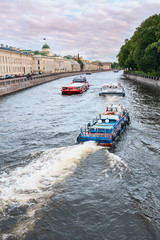 Fototapeta premium View of the Fontanka River with pleasure boats and the embankment in St. Petersburg, Russia